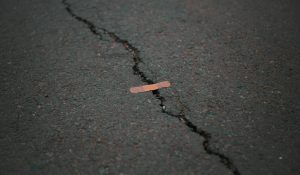 bandaid placed over a crack in a road